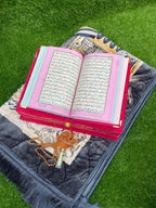 Quran GIft with gold designs on a prayer mat