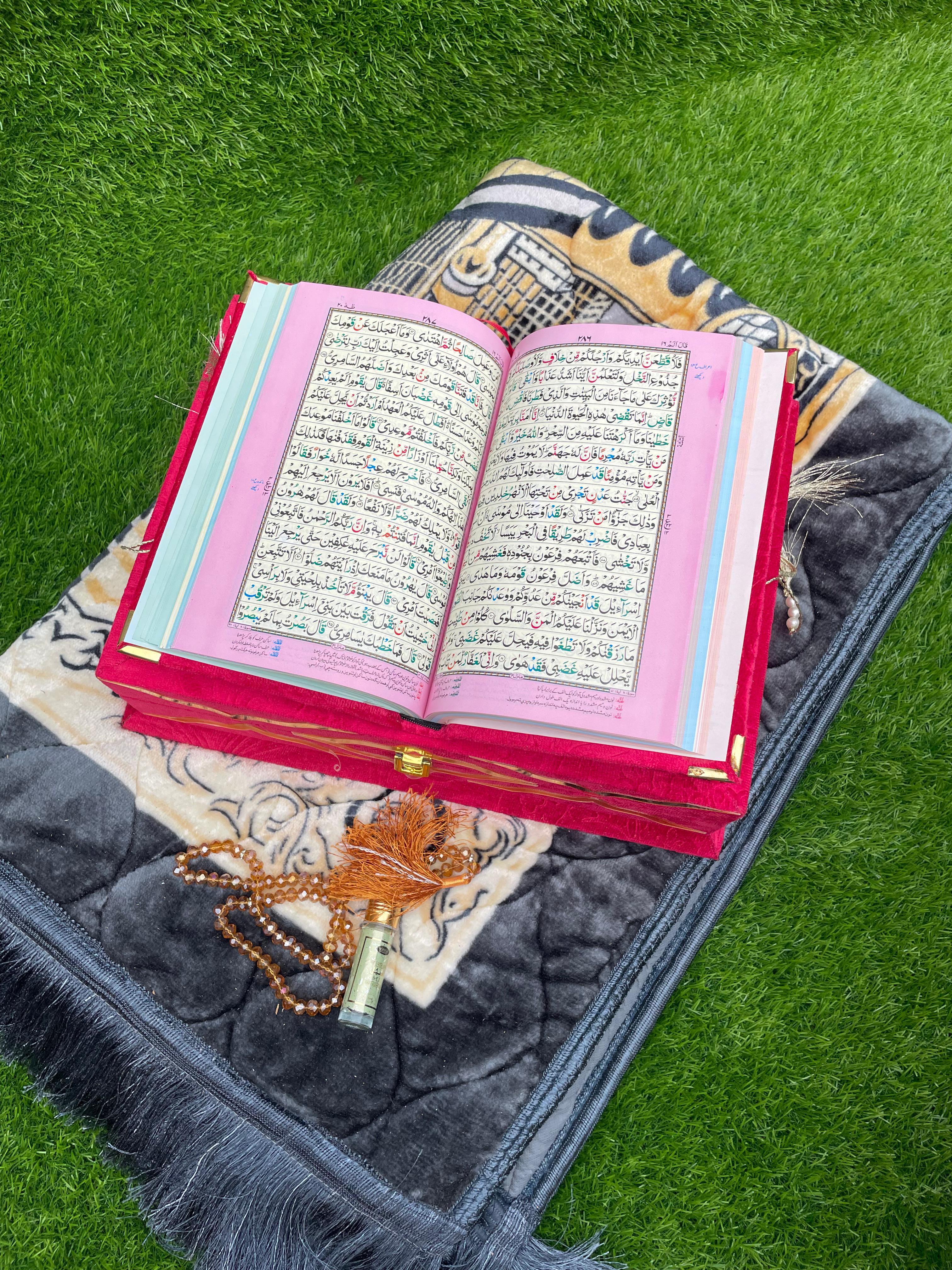 Quran GIft with gold designs on a prayer mat